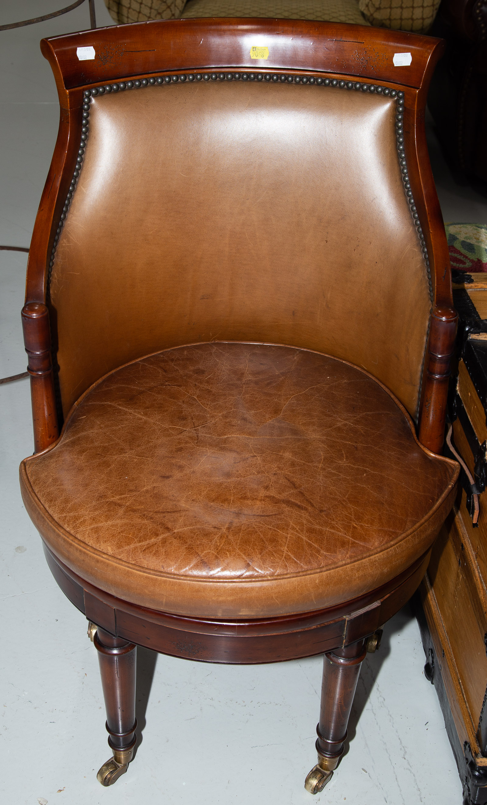 Appraisal: REGENCY STYLE CHERRY SWIVEL DESK CHAIR Contemporary with leather upholstery