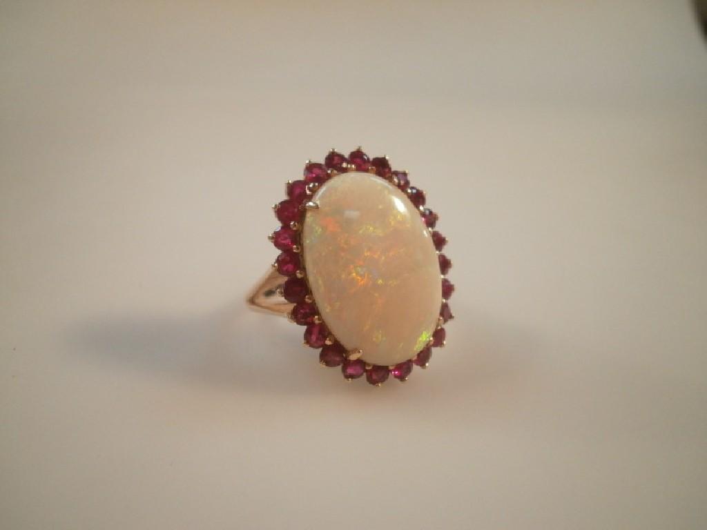 Appraisal: A large opal cabochon mm x mm and ruby surround