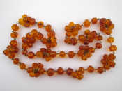 Appraisal: An amber bead necklace beads approx - mm wide approx