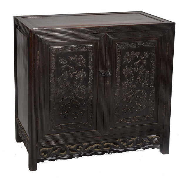 Appraisal: A CHINESE HARDWOOD CUPBOARD with carved prunus panel doors and