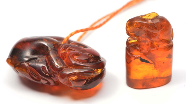 Appraisal: A CHINESE CARVED AMBER PENDANT in the form of a