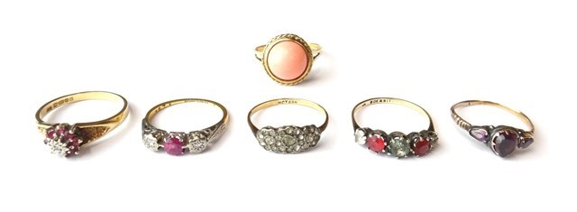 Appraisal: A gold diamond and red gem set three stone ring