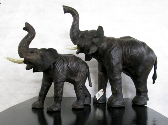 Appraisal: TWO LEATHER STANDING ELEPHANT FIGURES large and small versions of