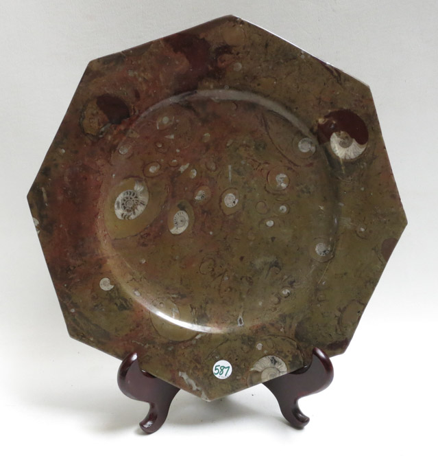 Appraisal: A LARGE AMMONITE FOSSIL OCTAGONAL PLATE with wood plate stand