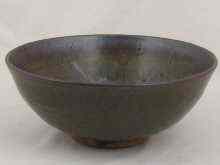 Appraisal: A ceramic stoneware bowl with heavy brown and green streaked