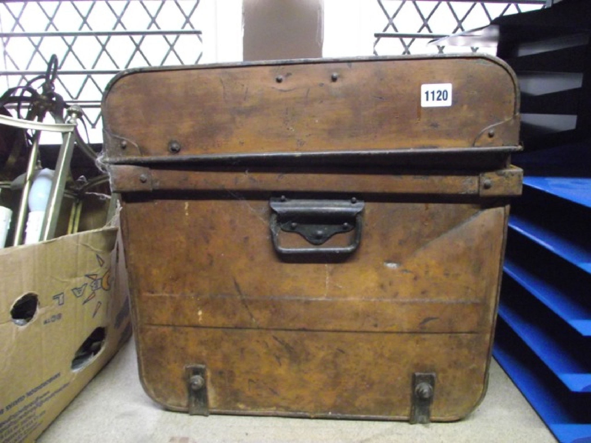 Appraisal: A Victorian tin trunk with simulated wood grain finish containing