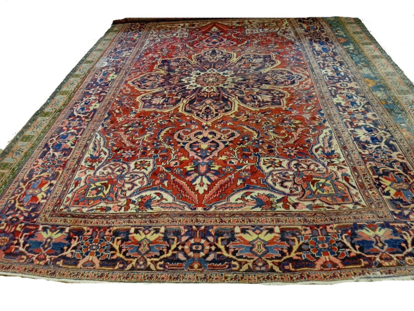 Appraisal: An Heriz carpet Persian the madder field with a bold