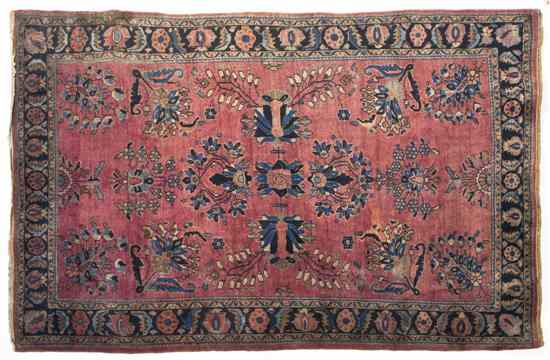 Appraisal: A Sarouk Wool Rug having a stylized foliate center medallion