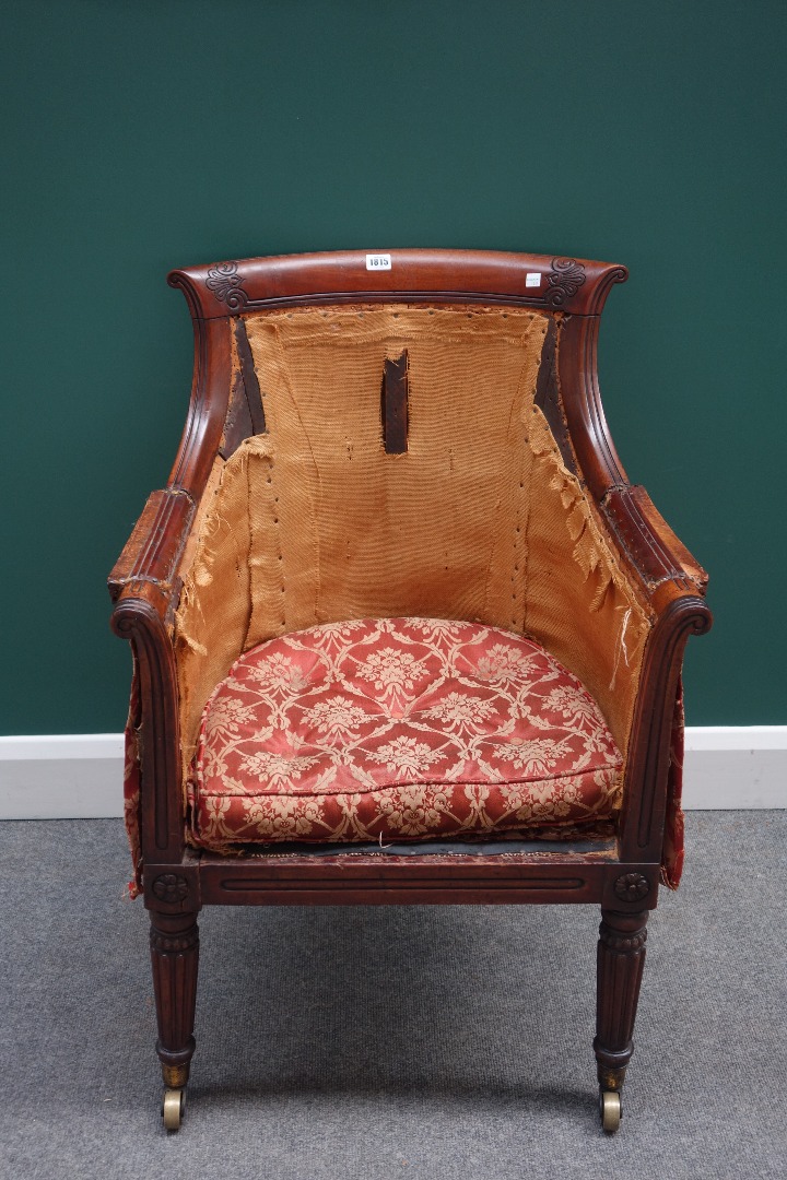 Appraisal: A Regency mahogany framed library bergere with downswept arms and