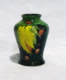 Appraisal: A Moorcroft green ground Leaf and Berry miniature vase c