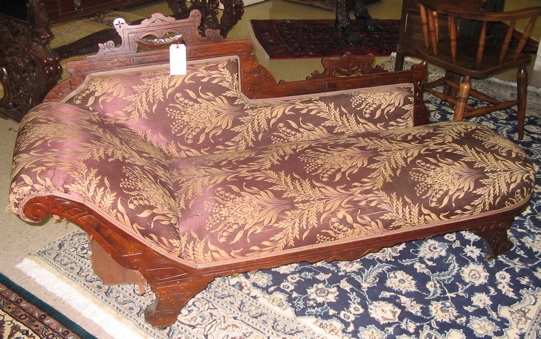 Appraisal: A VICTORIAN CARVED AND UPHOLSTERED WALNUT CHAISE LOUNGE Eastlake design