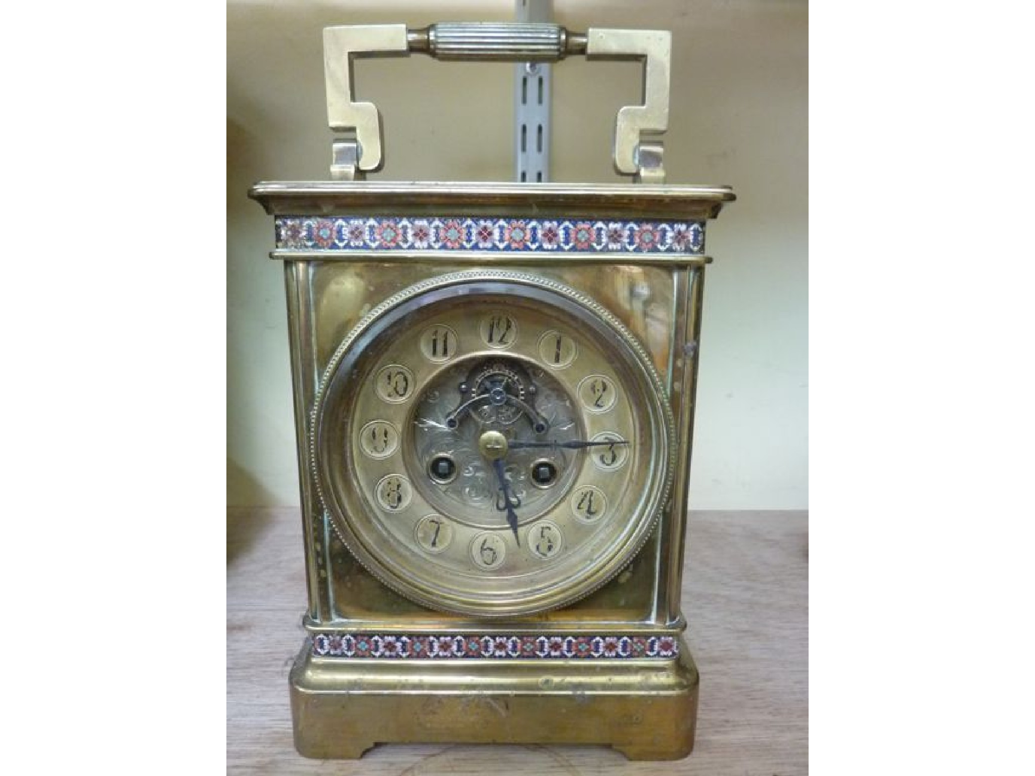 Appraisal: A th century brass table clock with champleve enamelled borders