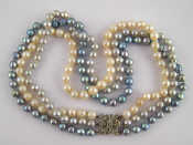 Appraisal: A three colour three row cultured pearl necklace with white