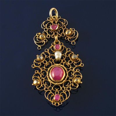 Appraisal: A ruby diamond and pearl gold pendant the open scroll