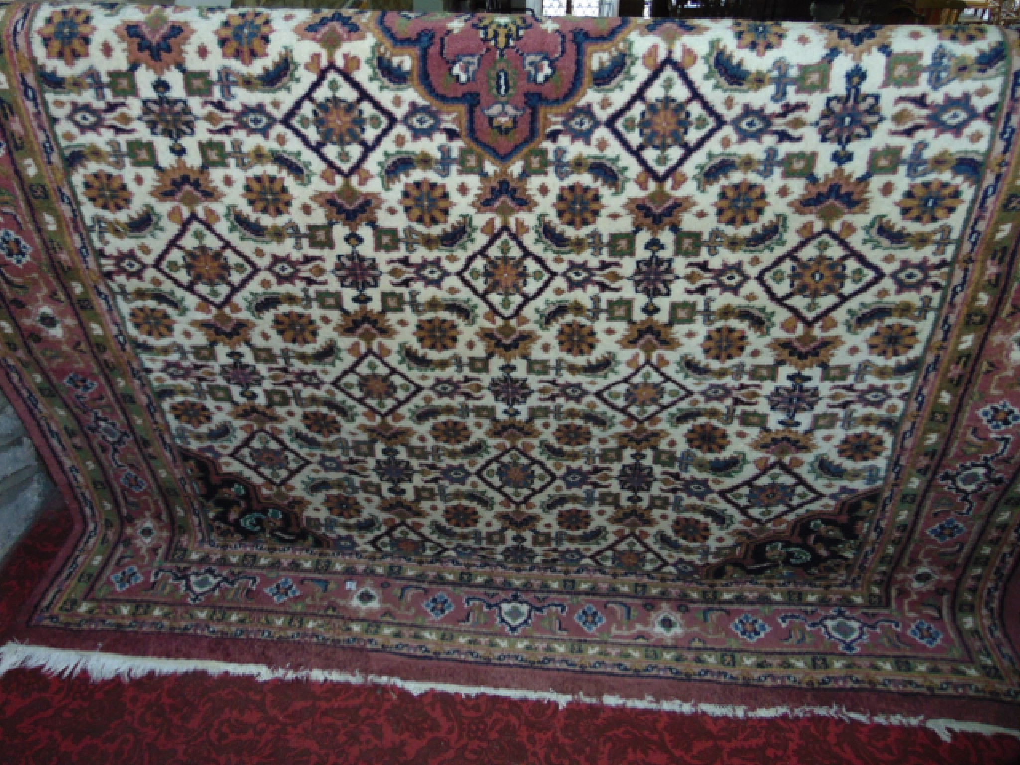 Appraisal: A Persian style wool carpet with white ground and central