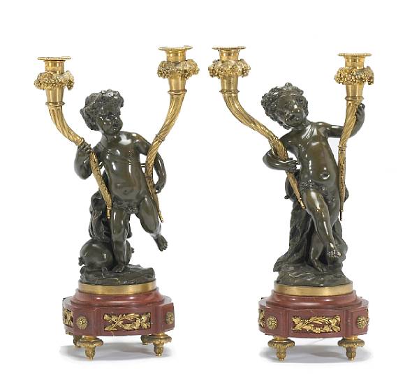 Appraisal: Each dancing putto holding in each arm a cornucopia inset