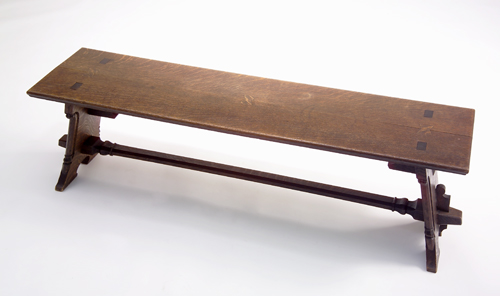 Appraisal: ROSE VALLEY Carved oak trestle bench the stretcher mortised through