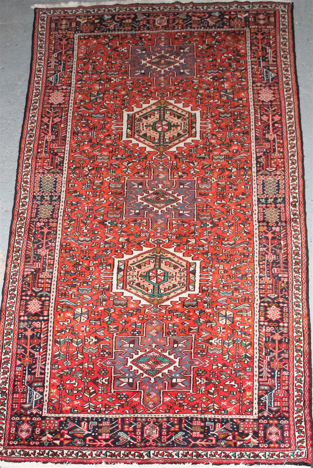 Appraisal: TRIBAL WOOL RUG WITH THREE MEDALLIONS approx ' x '