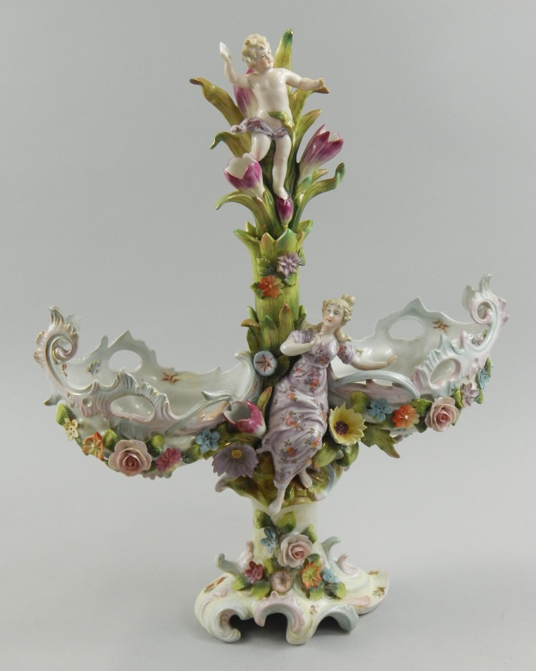 Appraisal: A Continental porcelain centrepiece decorated with putti female figure and