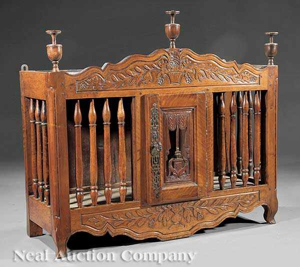 Appraisal: An Antique French Provincial Carved Walnut Paneti re urn finials