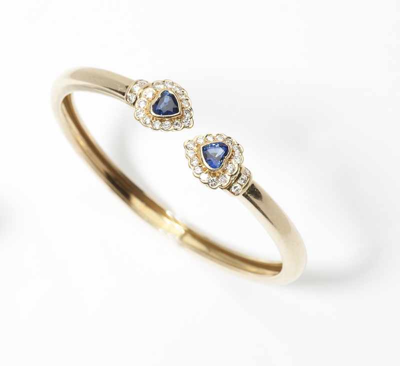 Appraisal: Italian K gold flexible bangle set with heart-shaped sapphire terminals