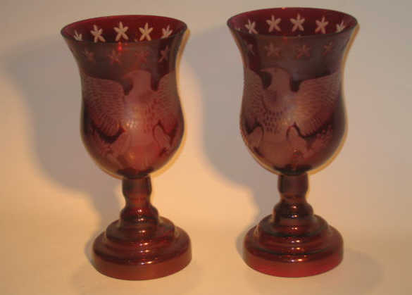 Appraisal: PAIR OF AMERICAN ETCHED RED GLASS CANDLE HOLDERS The flaring