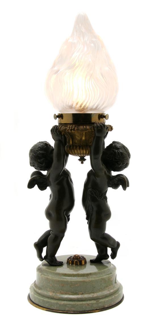 Appraisal: French Bronze Figural Lamp depicting two cherubs supporting the lighting