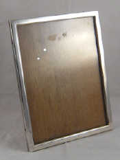 Appraisal: A silver photo frame with oak back and strut marked