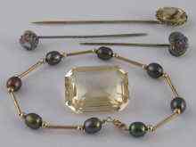 Appraisal: A mixed lot comprising three stick pins a loose polished