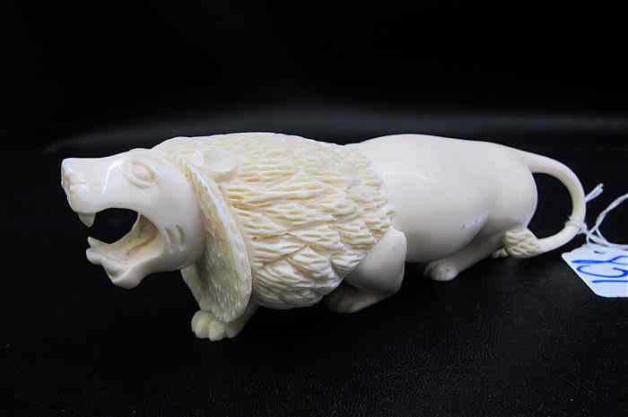 Appraisal: AFRICAN CARVED IVORY LION a full maned male open-mouthed in