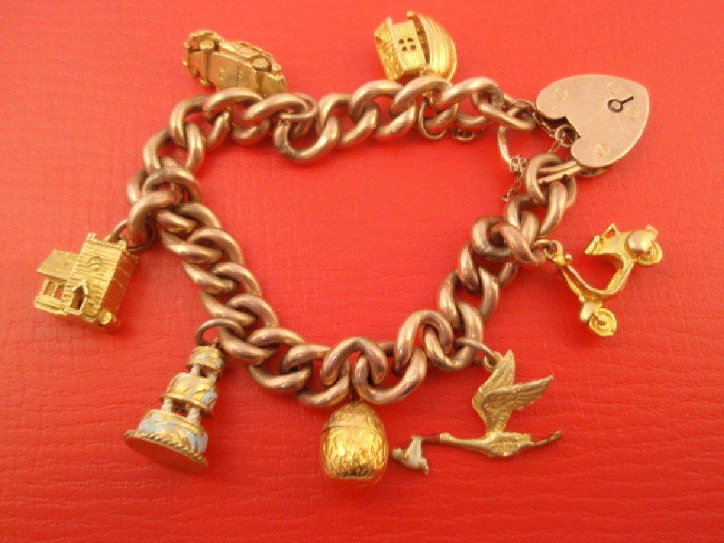 Appraisal: A ct rose gold curb link charm bracelet with seven