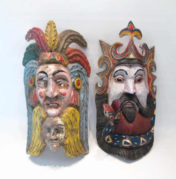 Appraisal: TWO SOUTHEAST ASIAN MASKS hand carved and paint decorated in