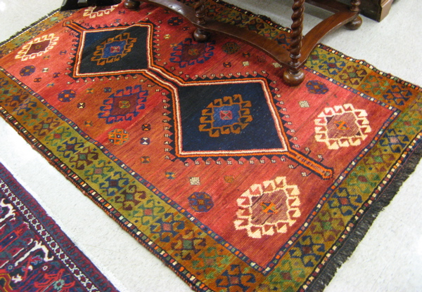 Appraisal: PERSIAN SHIRAZ AREA RUG double geometric medallions surrounded by a