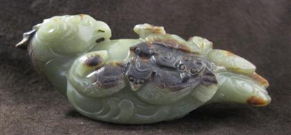 Appraisal: Chinese green and brown jade bird The archaic-style carving depicts