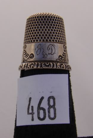 Appraisal: KMD sterling thimble with ornately decorated band rim