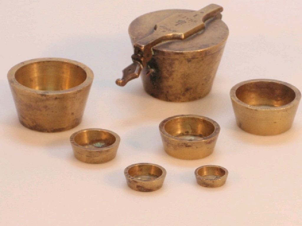 Appraisal: A set of thC brass cup weights contained within the