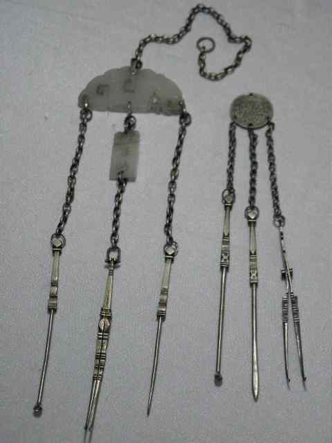 Appraisal: Two Chinese silver metal opium tool chatelaines First chatelaine has