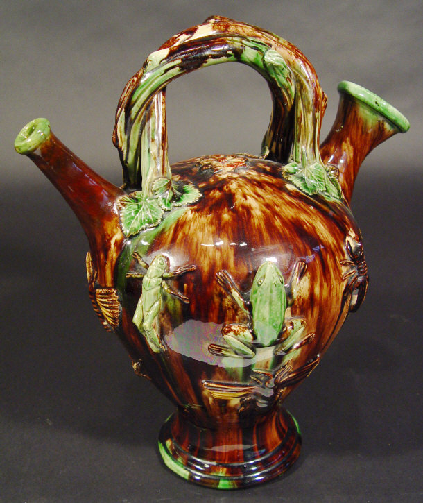 Appraisal: Portuguese Palissy style pottery ewer moulded with a branch handle