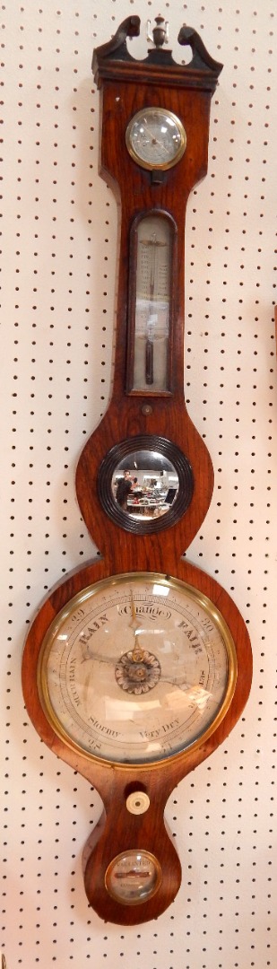 Appraisal: A George III rosewood wheel barometer silvered dial thermometer and