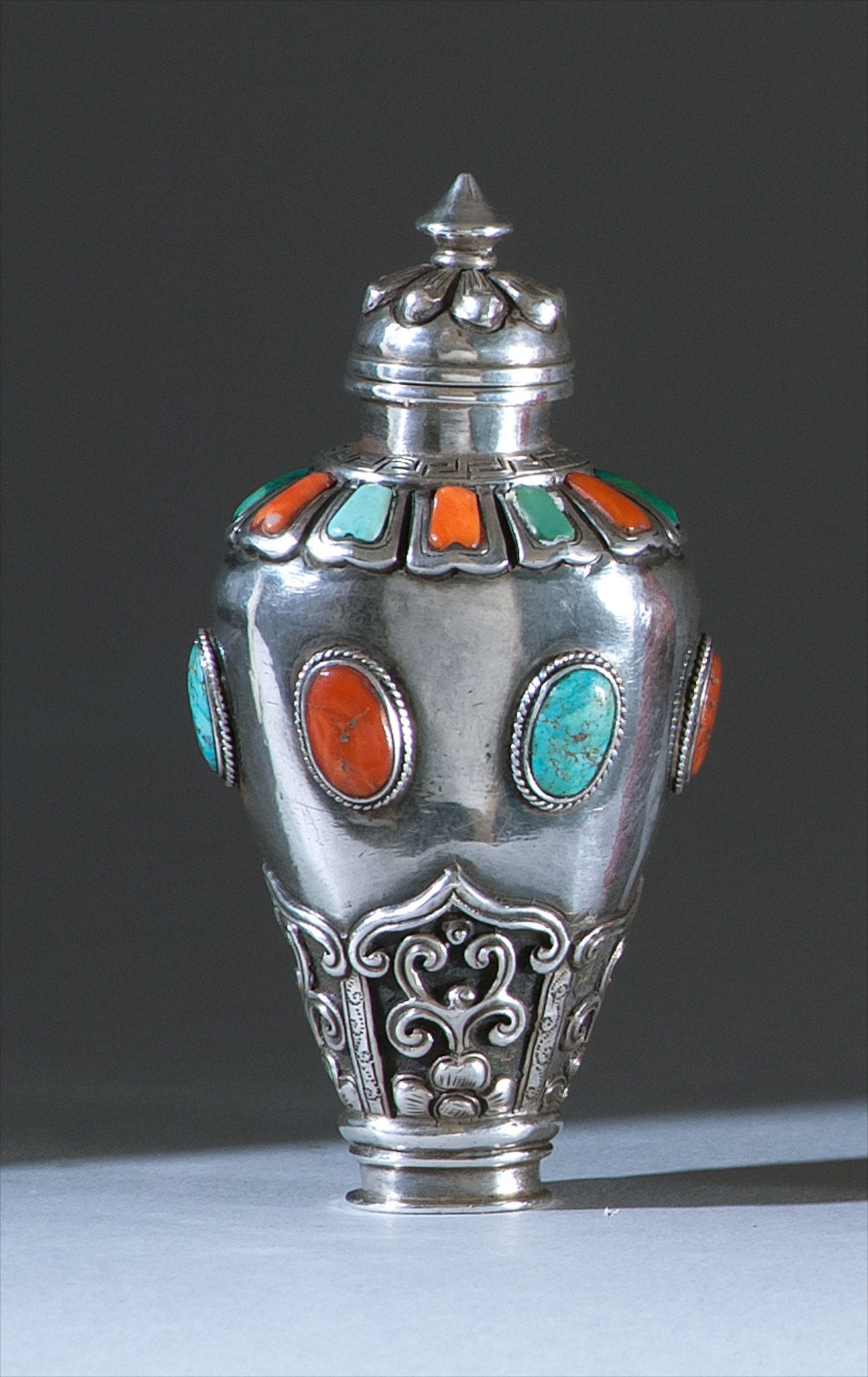 Appraisal: MONGOLIAN-STYLE INLAID SILVER SNUFF BOTTLE th CenturyIn temple jar form