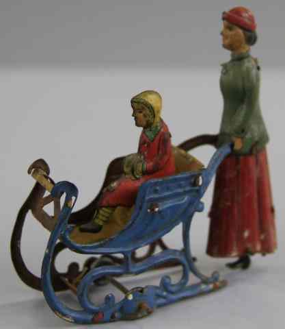 Appraisal: WOMAN PUSHING CHILD IN SLEIGH PRAM PENNY TOY Meier Germany