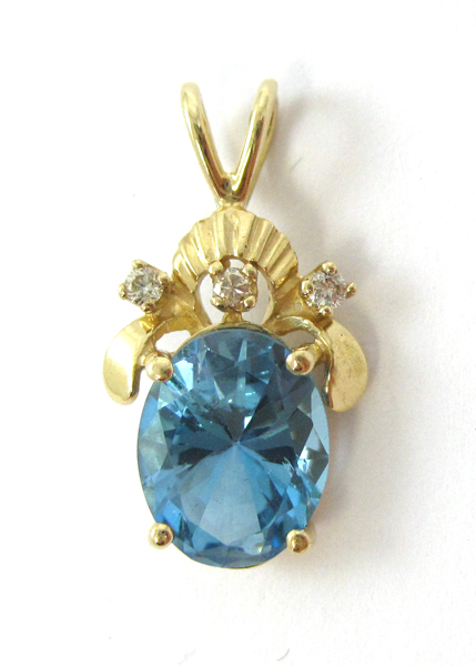 Appraisal: BLUE TOPAZ AND DIAMOND PENDANT k yellow gold with three