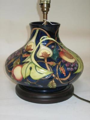 Appraisal: A MOORCROFT POTTERY LAMP of squat form tube lined with