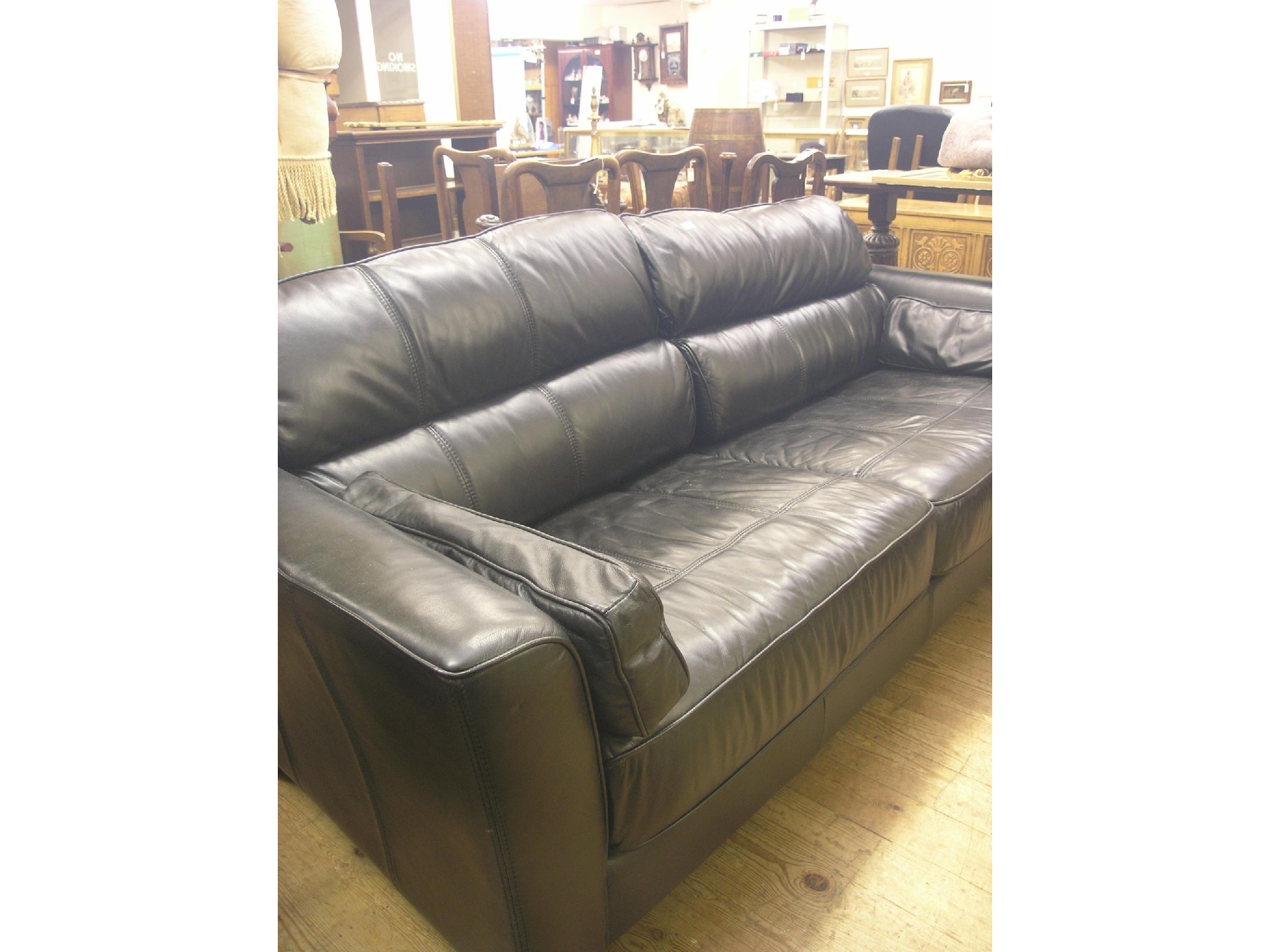 Appraisal: A modern black leather three-seater settee with loose cushions