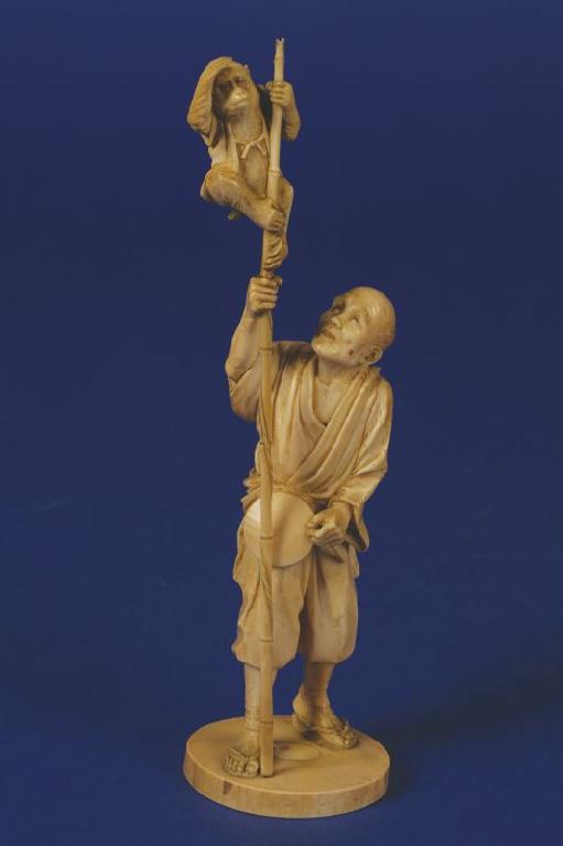 Appraisal: TOKYO SCHOOL A CARVED IVORY OKIMONO OF A STREET PLAYER