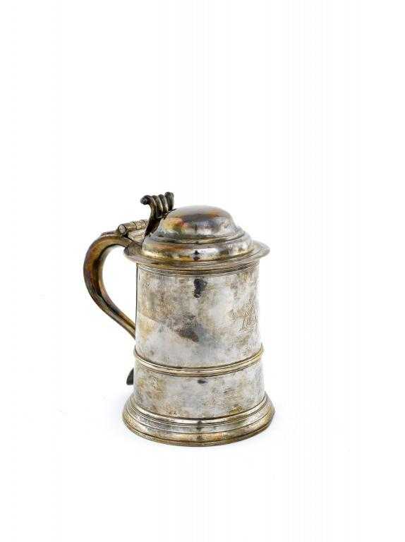 Appraisal: A GEORGE II TANKARD with domed lid and scroll thumbpiece