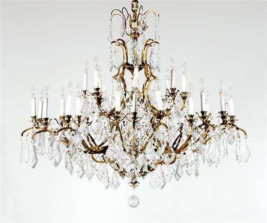 Appraisal: Continental bronze and crystal thirty-two light chandelier scrolling arms hung