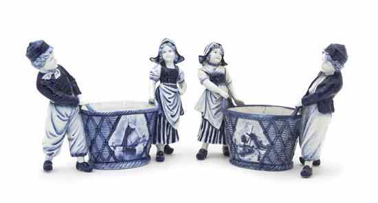 Appraisal: A Pair of Delft Ceramic Figural Jardinieres in the form