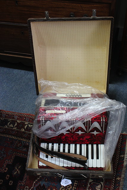 Appraisal: A LYRA PIANO ACCORDION with a red coloured plastic case