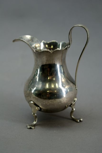 Appraisal: A pear shaped footed sterling silver creamer makers mark indistinct